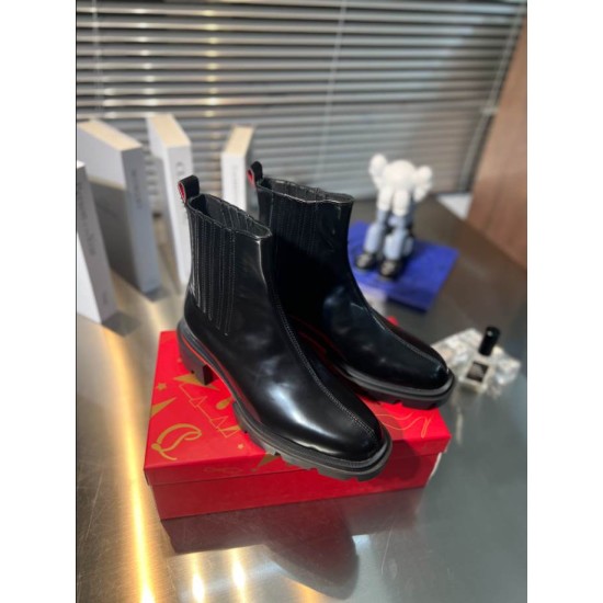 Christian Louboutin Men's Black Leather Chelsea Boots Pair Display Pair of Christian Louboutin Men's Black Leather Lug Sole Chelsea Boots presented on a red box.