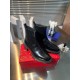 Christian Louboutin Men's Black Leather Chelsea Boots Pair Display Pair of Christian Louboutin Men's Black Leather Lug Sole Chelsea Boots presented on a red box.