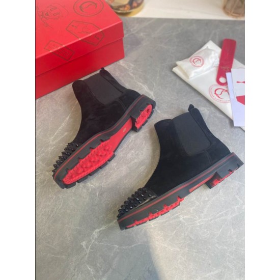 Christian Louboutin Men's Black Studded Suede Chelsea Boots Outsole Detail Christian Louboutin Men's Black Studded Suede Chelsea Boots positioned to highlight the treaded red sole