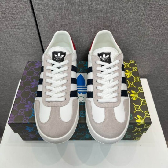 Front View of Gucci Gazelle White Trainers in white and black Front view of both Gucci Gazelle white leather trainers displaying laces and tongue logo in white and black