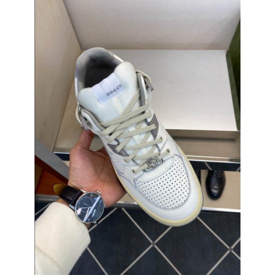 Gucci White Trainer Handheld Front Angle in white and grey Hand holding Gucci white leather trainer highlighting vamp perforations and grey accents