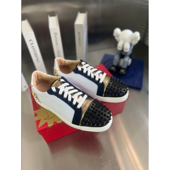 Christian Louboutin Low Top Mesh Spiked Trainers Pair View in black and white Angled view of a pair of Christian Louboutin black, white, and gold trainers on display