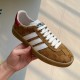 Gucci Gazelle Yellow Canvas Trainer Lateral View in yellow and white Handheld lateral side view of the yellow canvas Gucci Gazelle trainer highlighting white side stripes