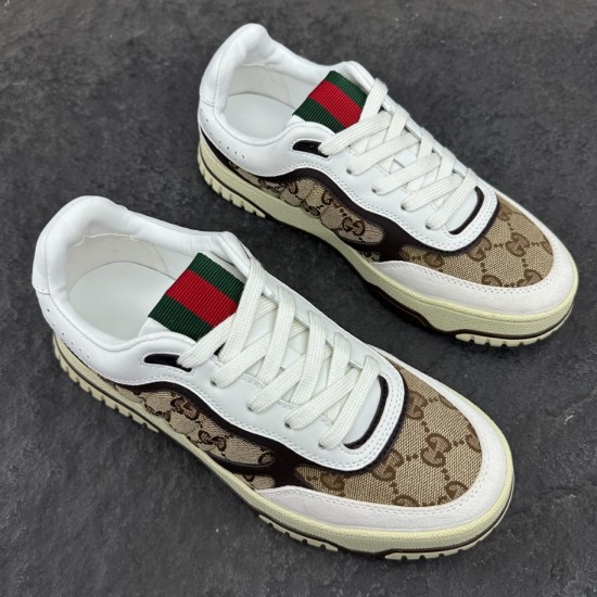 Gucci Re-Web GG Canvas Trainers Pair Overhead in beige and white Pair of Gucci Re-Web GG Canvas Trainers In Beige Ebony viewed from above on dark stone background in beige and white