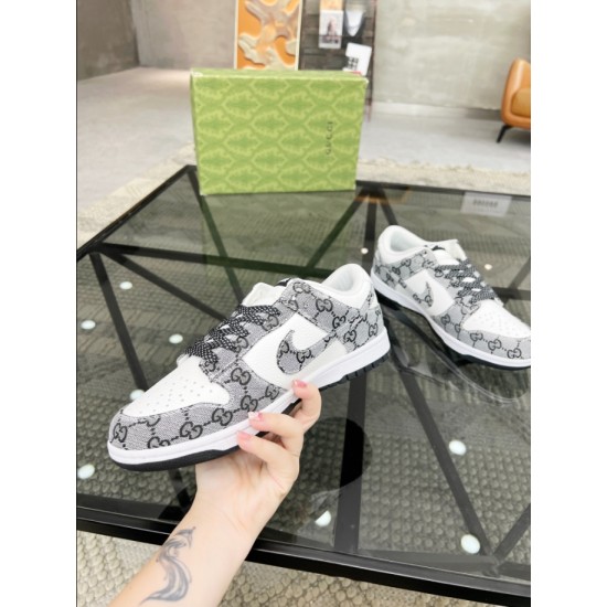 Gucci Low Top Trainer Held View in white and black Hand holding a single Gucci white and black low top trainer