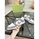 Gucci Low Top Trainer Held View in white and black Hand holding a single Gucci white and black low top trainer