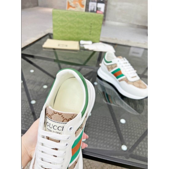 Close-up of Gucci white trainer tongue with brand label, green padded collar and white laces in white and beige