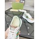 Close-up of Gucci white trainer tongue with brand label, green padded collar and white laces in white and beige