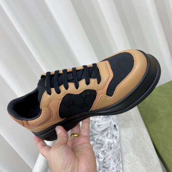 Gucci Monogram Leather Chunky Sole Trainers Black Brown Close-Up Close-up view of Gucci Monogram Leather Chunky Sole Trainer in hand showing lace details in black and brown