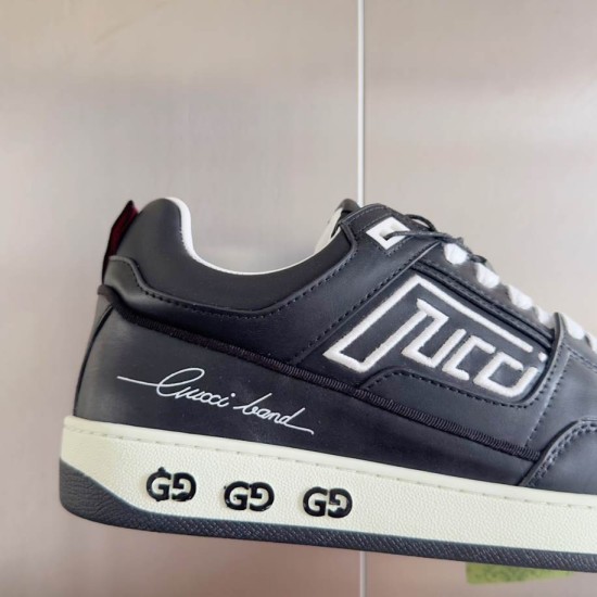 Gucci Black Leather Low Top Trainers close-up on side graphic and logo midsole in black and white