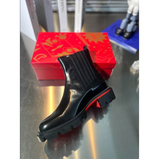 Christian Louboutin Men's Black Leather Chelsea Boots Perspective View Side perspective of Christian Louboutin Men's Black Leather Lug Sole Chelsea Boots resting on a red shoe box.