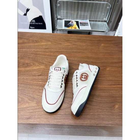 Front and side angle view showing two Gucci white leather trainers in white and brown