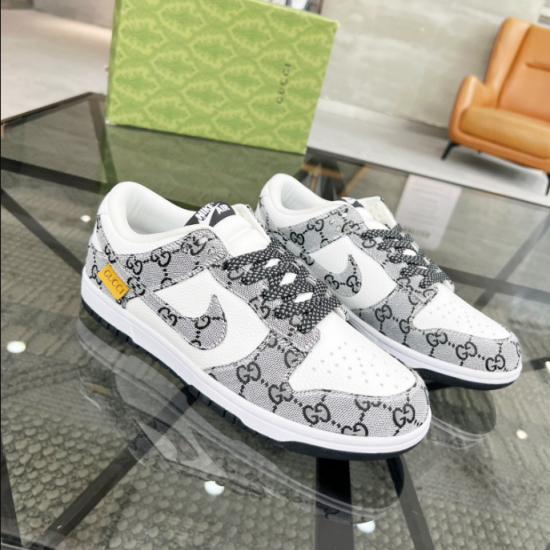 Gucci Low Top Jacquard Trainers Pair View in white and black Pair of Gucci low top jacquard trainers in white and black on a glass table