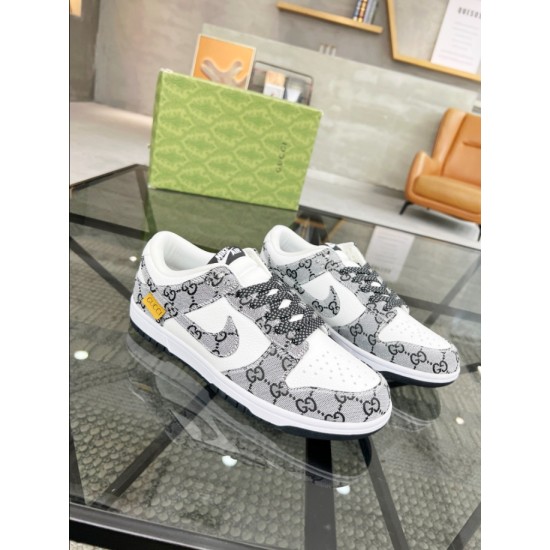 Gucci Low Top Trainers Angled View in white and black Angled perspective of Gucci white and black low top jacquard trainers