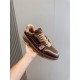 L Trainer Marron Brown Leather Low Top Sneakers held in hand