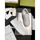 Overhead layout of Gucci white leather trainers beside original packaging documentation