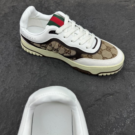 Gucci Re-Web GG Canvas Trainer Angled View in beige and white Angled top-down view of Gucci Re-Web GG Canvas Trainer in beige ebony showing green and red web tongue detail in beige and white