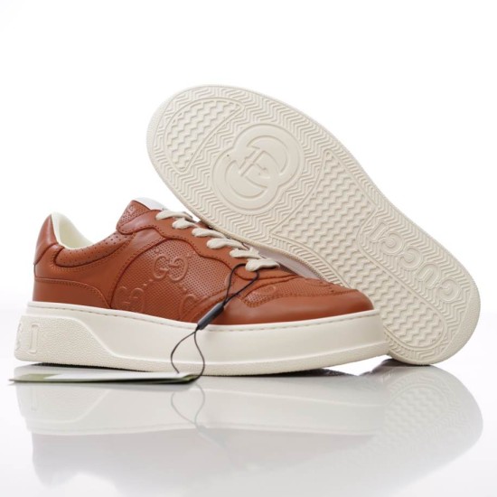 Side profile of Gucci brown trainer with rubber tread sole exposed