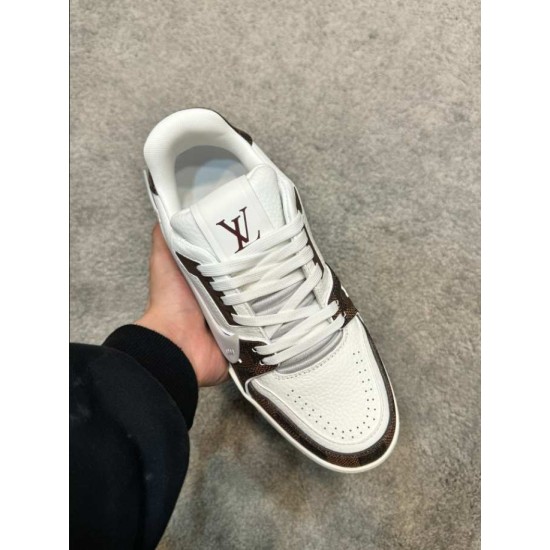 L Trainer Damier Leather White Brown Low Top Trainers Front Detail View Close-up view held in hand of L Trainer Damier leather white brown low top trainer showing white laces and tongue logo