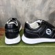 Rear heel view of Gucci black leather trainers showing white midsoles