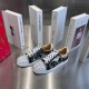 Christian Louboutin Graphic Printed Trainers Pair in black and white Pair of Christian Louboutin black and white printed trainers displayed on a grey surface