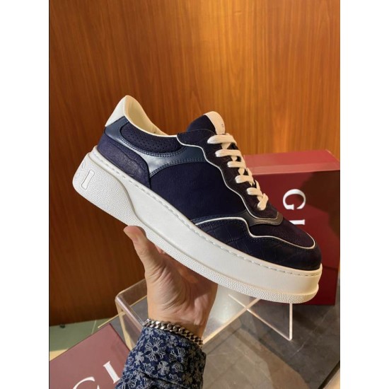 Gucci Lace-Up Dark Navy Blue And White Trainer Handheld View Hand holding a Gucci Lace-Up Dark Navy Blue And White Trainer showing outer side view