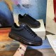 Alexander McQueen Black Transparent Sole Trainers Handheld View Alexander McQueen Black Transparent Sole Lace-Up Trainers held at an angle