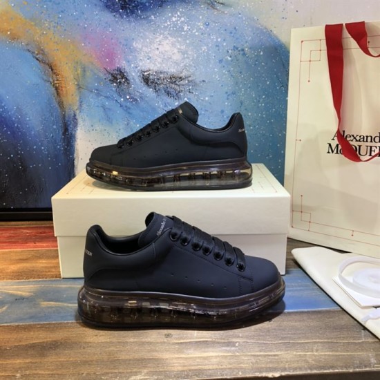 Alexander McQueen Black Transparent Sole Trainers Pair Stacked Alexander McQueen Black Transparent Sole Lace-Up Trainers pair arranged on shoe box
