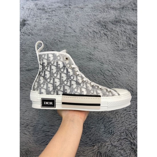 Lateral side profile of Dior B23 high-top white trainer held in hand