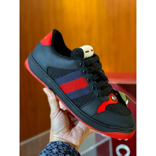 Gucci black and red web low top trainer close-up held view