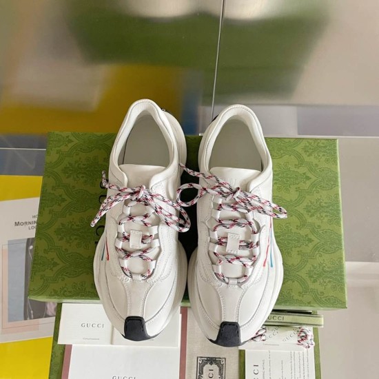 Gucci Run Leather Trainers In White Top View in white and red Gucci Run Leather Trainers In White top-down pair view showing patterned laces and dark toe cap detail in white and red
