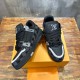 Angled pair display highlighting black and grey uppers of L Trainer Damier Denim Black Low Top Sneakers
