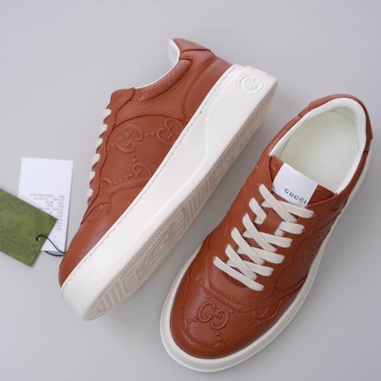 Top-down view of Gucci brown leather trainers alongside thick rubber sole detail