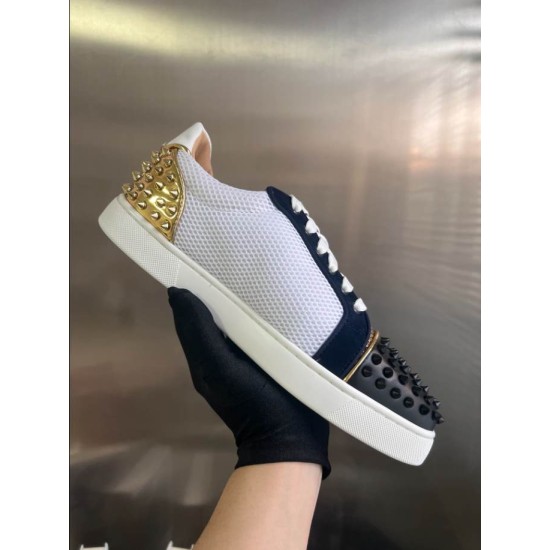 Christian Louboutin Low Top Mesh Spiked Trainers Handheld View in black and white Side view of Christian Louboutin black, white, and gold spiked trainers held in hand