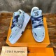 Angle View of L Bleached Monogram Denim Blue Low Top Trainers on Boxes Pair of L bleached monogram denim blue low top trainers displayed on orange boxes