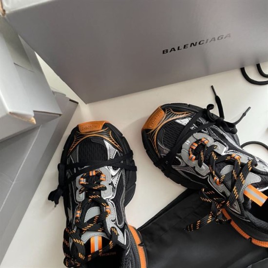 Front toe-cap detail of Balenciaga 3XL trainers showing orange accents and cage overlay in black and orange