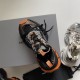 Top-down view of black and orange Balenciaga 3XL trainers with shoebox background