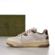 Medial side profile view of white and brown Gucci leather trainers