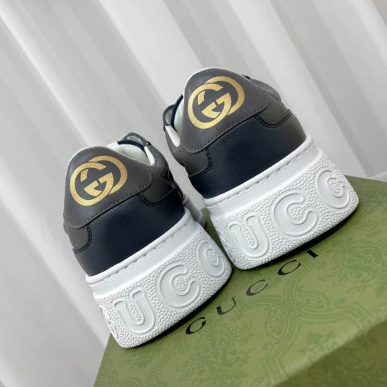 Rear view highlighting the gold-tone GG heel logos and embossed white midsoles on the Gucci trainers in grey and blue