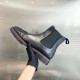 Hand holding Christian Louboutin Men's Spiked Chelsea Boots
