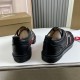 Rear view of Christian Louboutin Adolescenza black leather trainers showing heel panels and soles in black and red