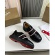 Angled pair view showing black leather upper and red underside of Christian Louboutin Adolescenza Trainers