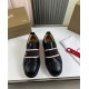 Front view of Christian Louboutin Adolescenza Leather Slip-On Trainers in black showing striped elastic strap in black and red