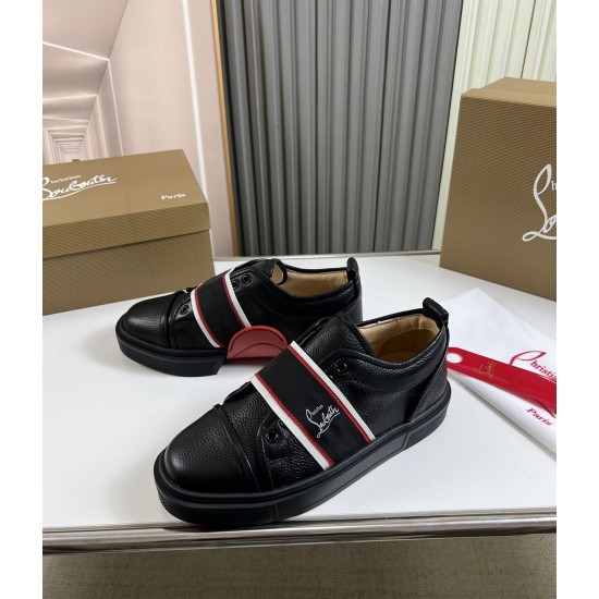 Pair of Christian Louboutin Adolescenza Leather Slip-On Trainers in black displayed on table with shoe box in black and red