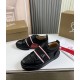Pair of Christian Louboutin Adolescenza Leather Slip-On Trainers in black displayed on table with shoe box in black and red