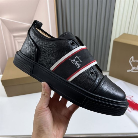 Close-up hand view of Christian Louboutin Adolescenza black textured leather trainer and thick sole