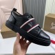 Close-up hand view of Christian Louboutin Adolescenza black textured leather trainer and thick sole