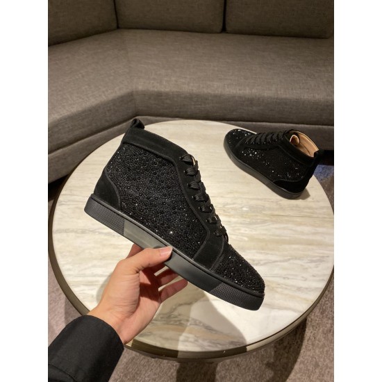 Hand holding Christian Louboutin black embellished high top trainer