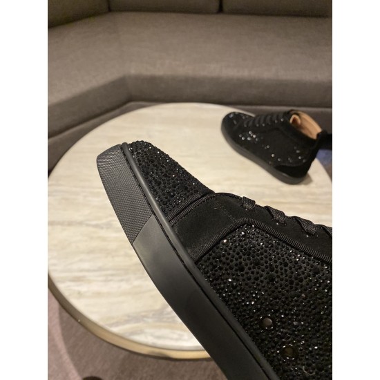 Close-up of black crystal embellishments and toe cap on Christian Louboutin trainer
