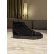 Side view of Christian Louboutin black crystal embellished high top trainer on table